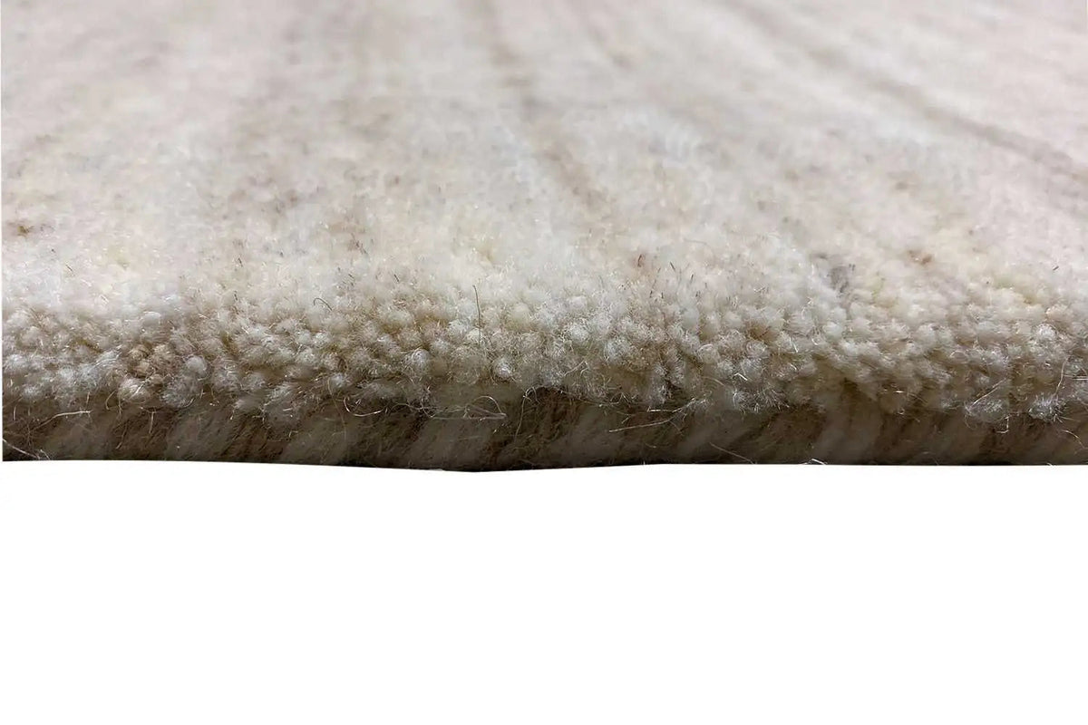 Light beige carpet pile with a dense, short woven edge