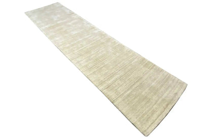 Beige runner, positioned diagonally, with a simple texture and no eye-catching patterns