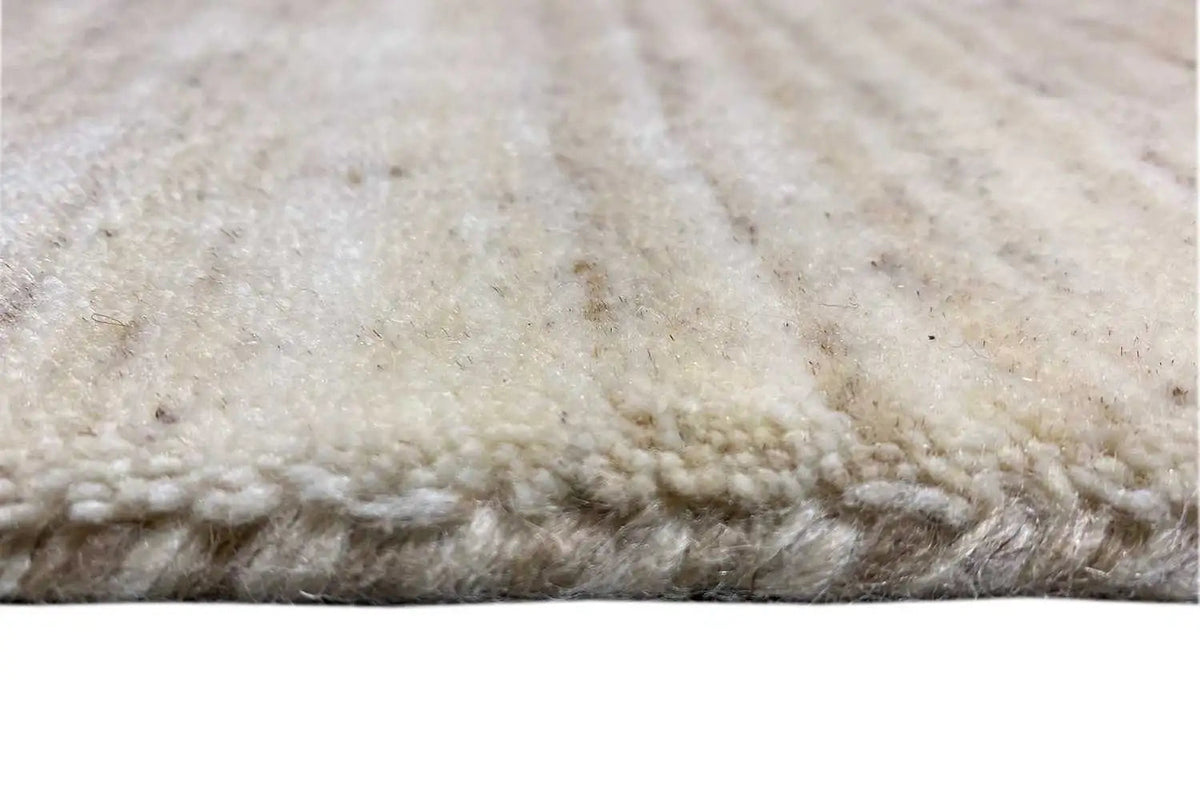 Close-up: beige runner rug with fringed edges and dense pile