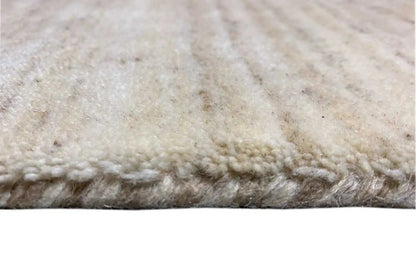 Close-up: beige runner rug with fringed edges and dense pile
