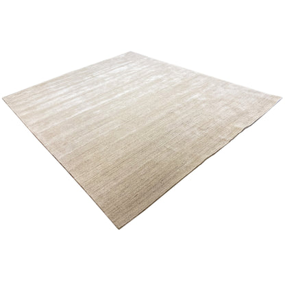 Beige carpet with light lines and a fine woven texture, viewed diagonally