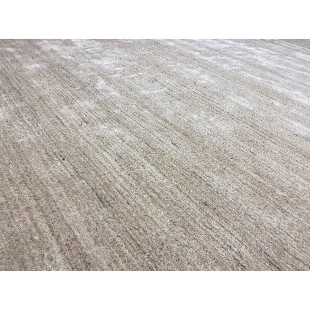 Close-up: beige rug with a fine texture and faded-looking stripes