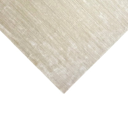 Beige carpet corner with an even surface and a delicate, light-colored pattern