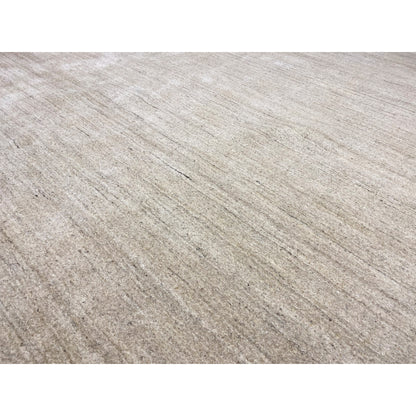 Close-up: beige carpet with a fine linear texture and subtly mottled look