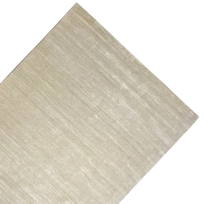 Beige carpet viewed diagonally from above, with a visibly uniform, textured surface