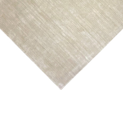 Beige diagonal rug: clean shape, matte surface with a fine, gridded texture