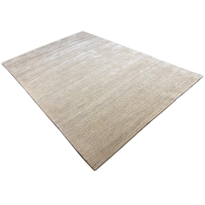 Beige carpet in close-up, uniform texture with a subtle gradient