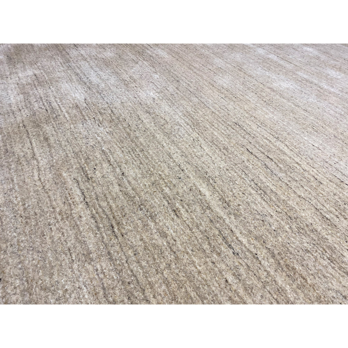Close-up of the beige carpet: fine, heathered fibers and an even surface