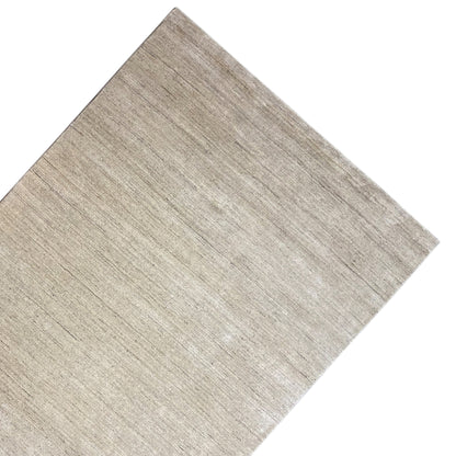Beige carpet viewed at an angle, smooth short-pile surface with a fine linear pattern