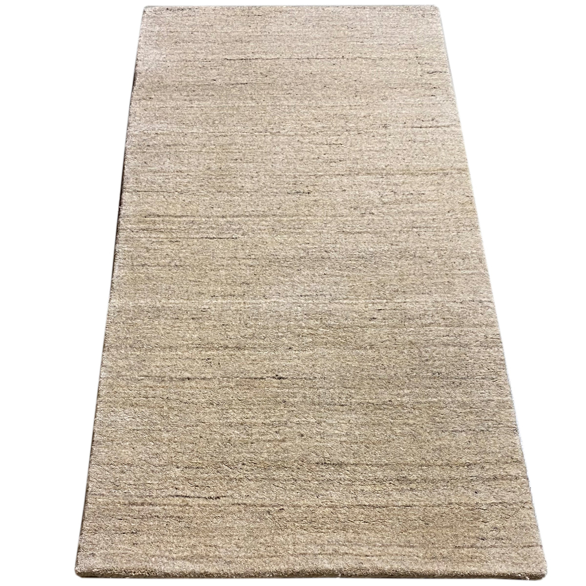 Rectangular rug in light beige with a delicate, wavy line pattern