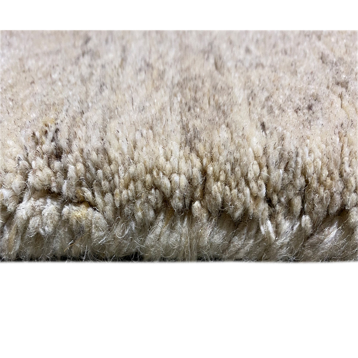 Close-up of carpet: dense pile, light beige fibers with a short, even looped texture