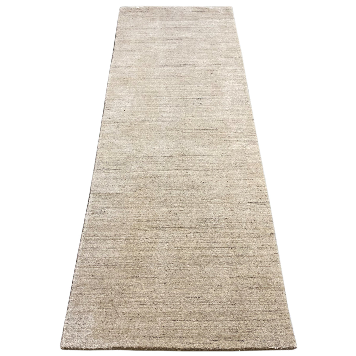 Rectangular runner rug, mottled beige, wide overview of the surface