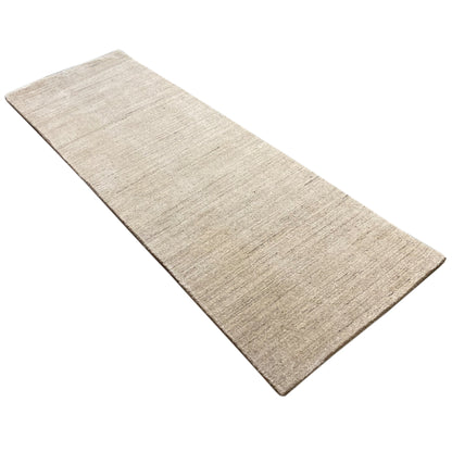 Beige rectangular rug, positioned at an angle, with an even surface