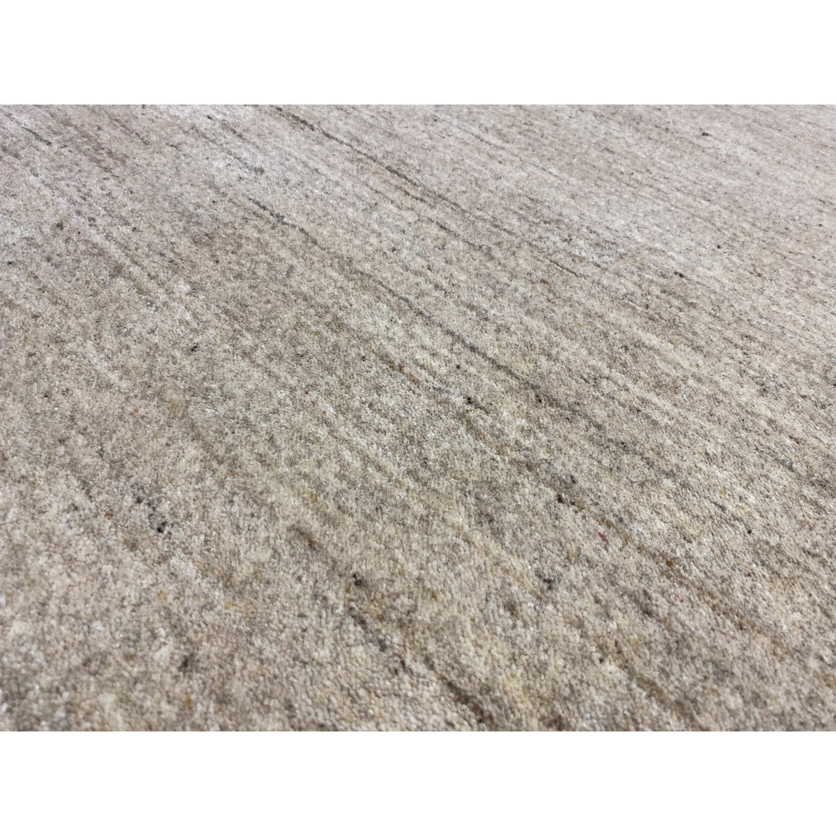 Close-up: beige heathered carpet surface with a fine texture
