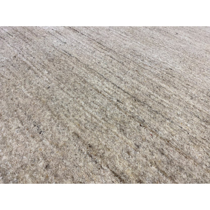 Close-up: beige heathered carpet surface with a fine texture