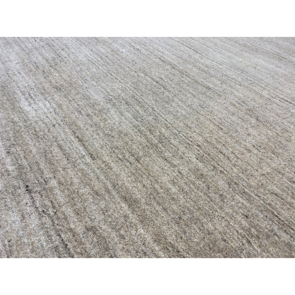 Close-up of the carpet surface: flat weave with fine beige and gray stripes