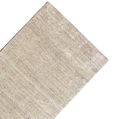 Beige carpet viewed from the corner, with a uniform texture and subtle stripes