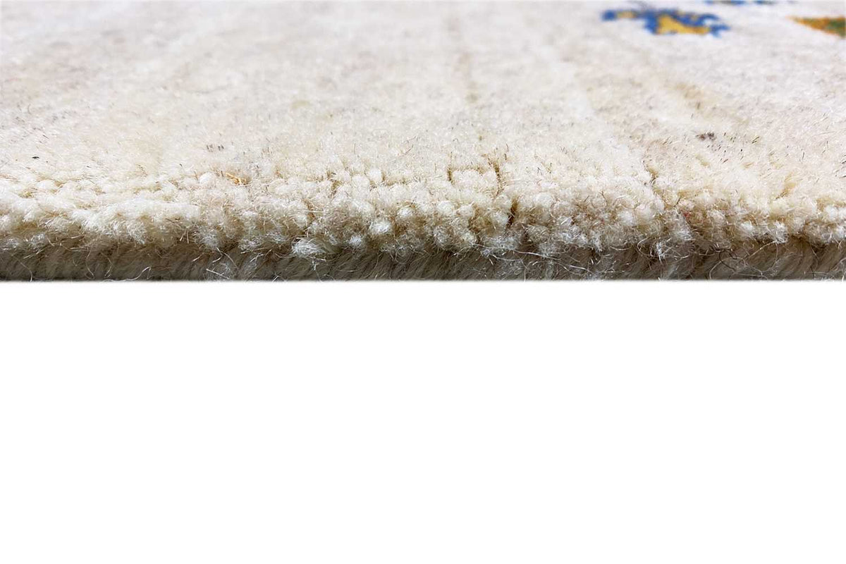 Close-up of Gabbeh runner: dense pile and fringed border, beige tone