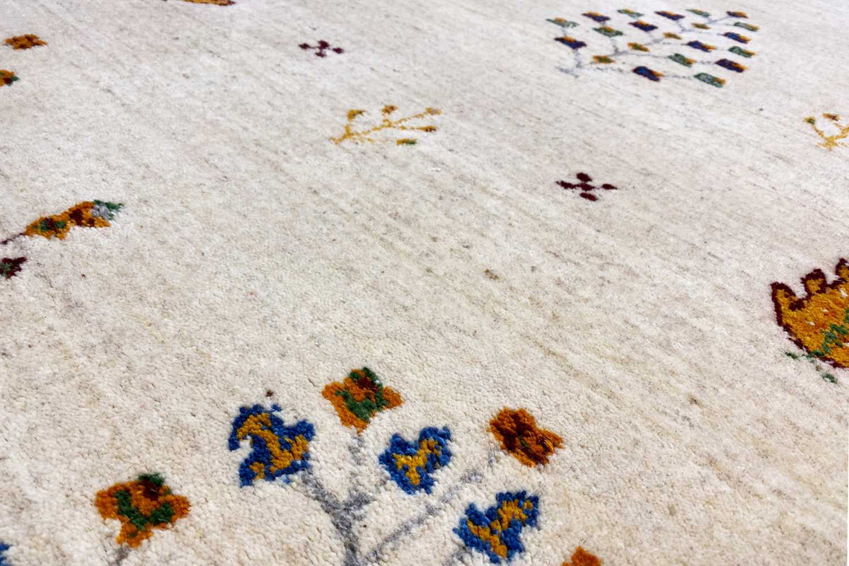 Gabbeh runner detail: woven structure with colorful motifs in blue, green, and orange