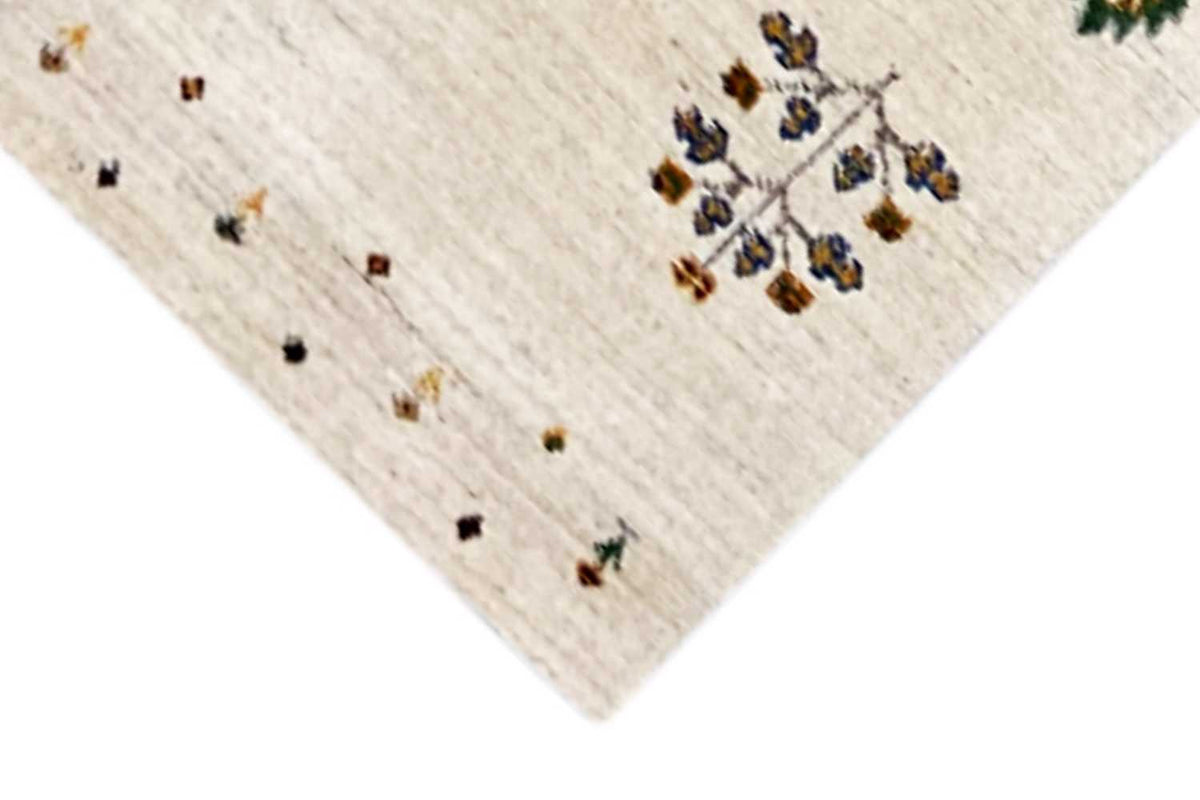 Gabbeh runner corner detail with a beige background and colorful star/floral pattern