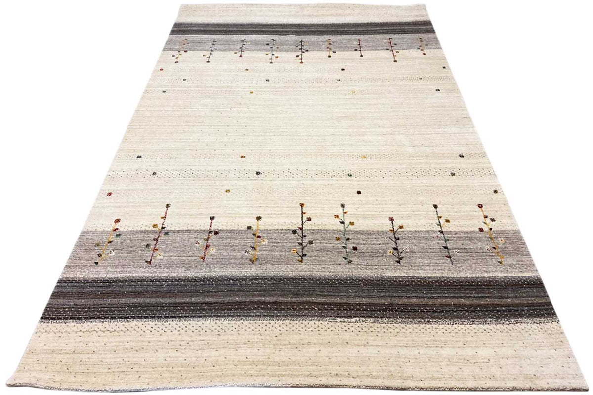 Beige Gabbeh rug with a dark central stripe and rows of small ornamental bars