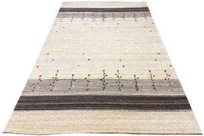 Beige Gabbeh rug with a dark central stripe and rows of small ornamental bars