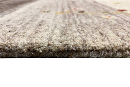 Gabbeh rug close-up: dense beige wool pile at the edge