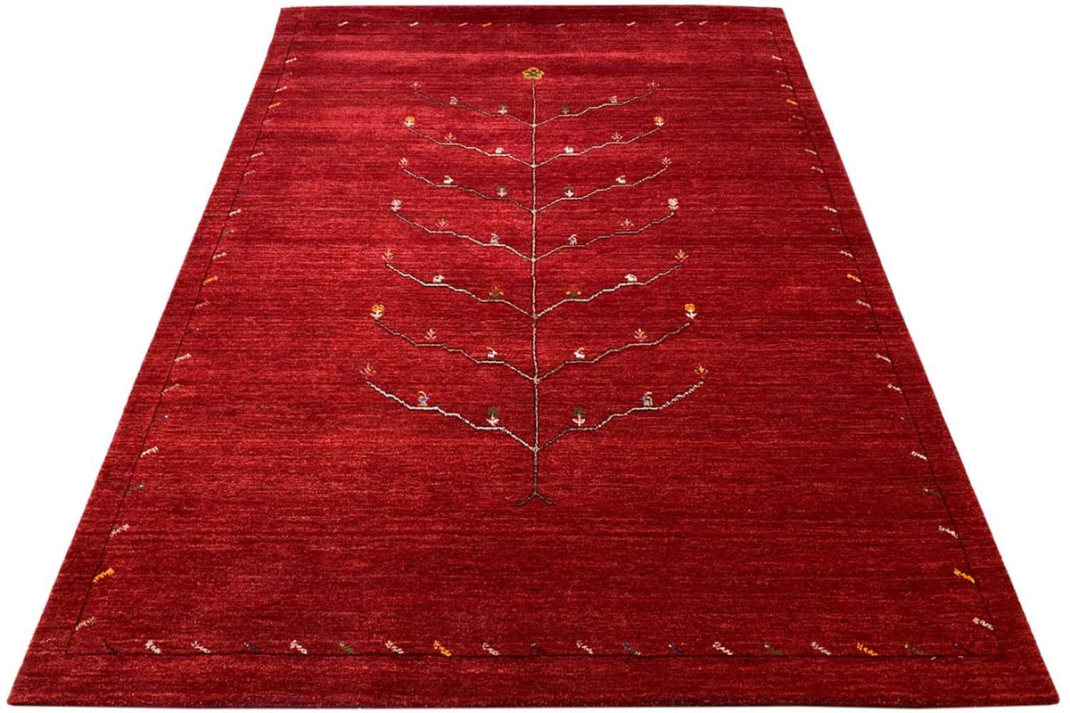 Red Gabbeh rug with a beige and gold tree-vine pattern