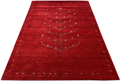 Red Gabbeh rug with a beige and gold tree-vine pattern