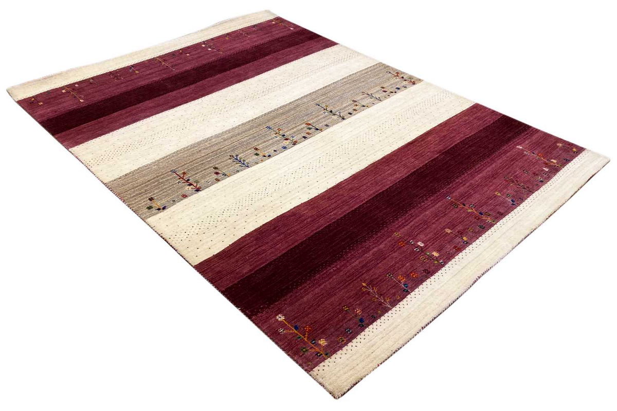 Gabbeh rug at an angle: burgundy and cream-colored stripes with ornaments