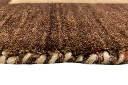Carpet pile in detail: brown and beige texture with a wavy edge.