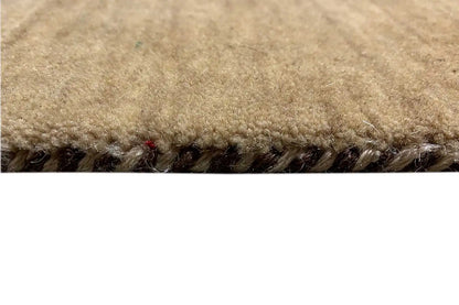 Gabbeh rug edge with dense pile and brown fringes, yarn texture visible