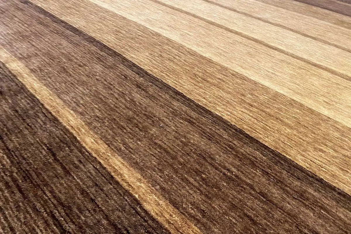 Close-up of a Gabbeh rug: brown and beige stripes, pile texture clearly visible