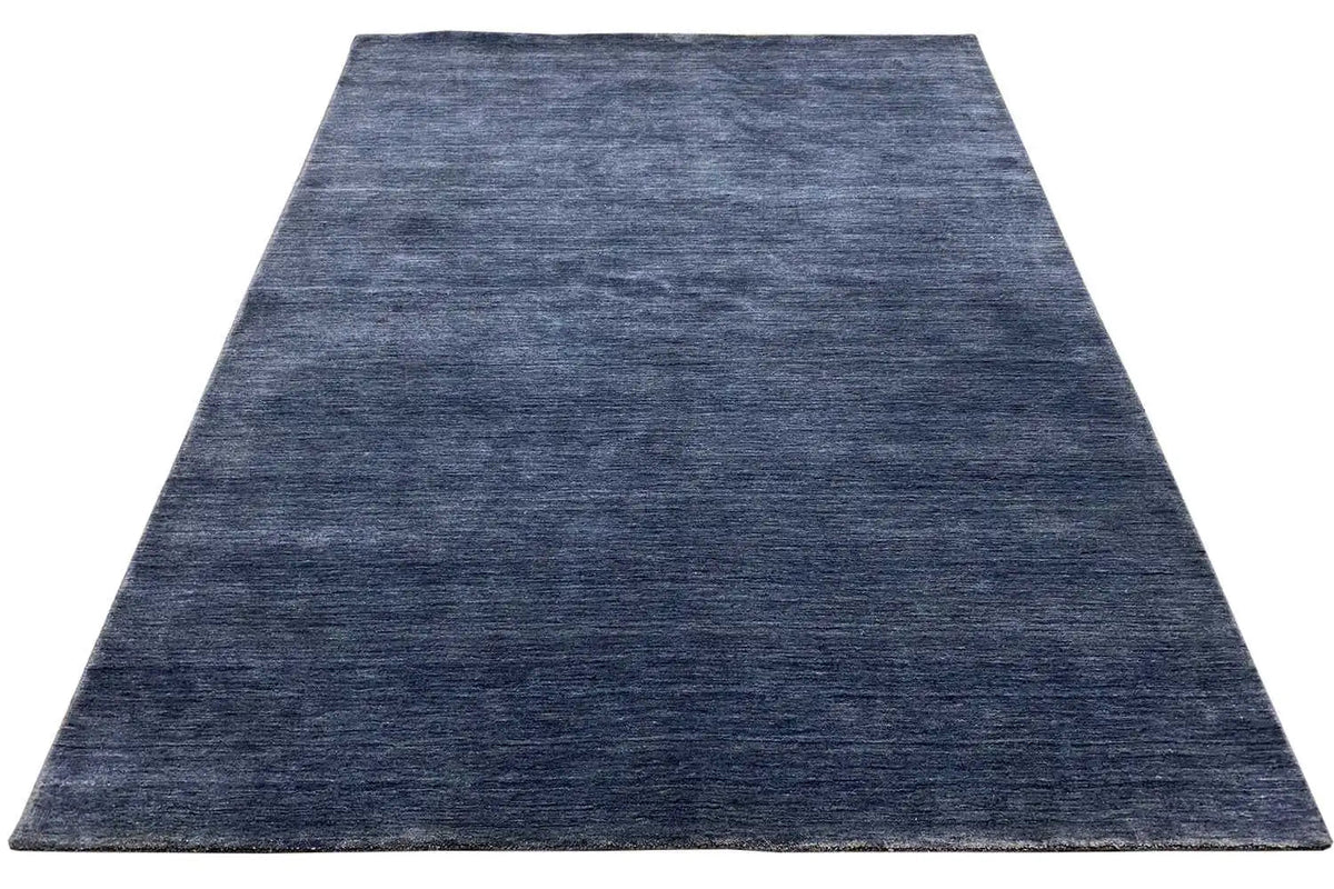 Blue Gabbeh rug with a short, even pile in a rectangular shape.