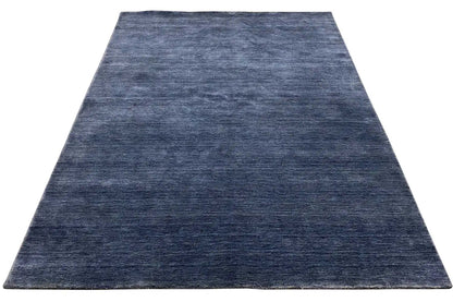 Blue Gabbeh rug with a short, even pile in a rectangular shape.
