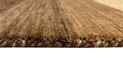 Close-up of the pile: brown-beige Gabbeh rug with a dense wool texture