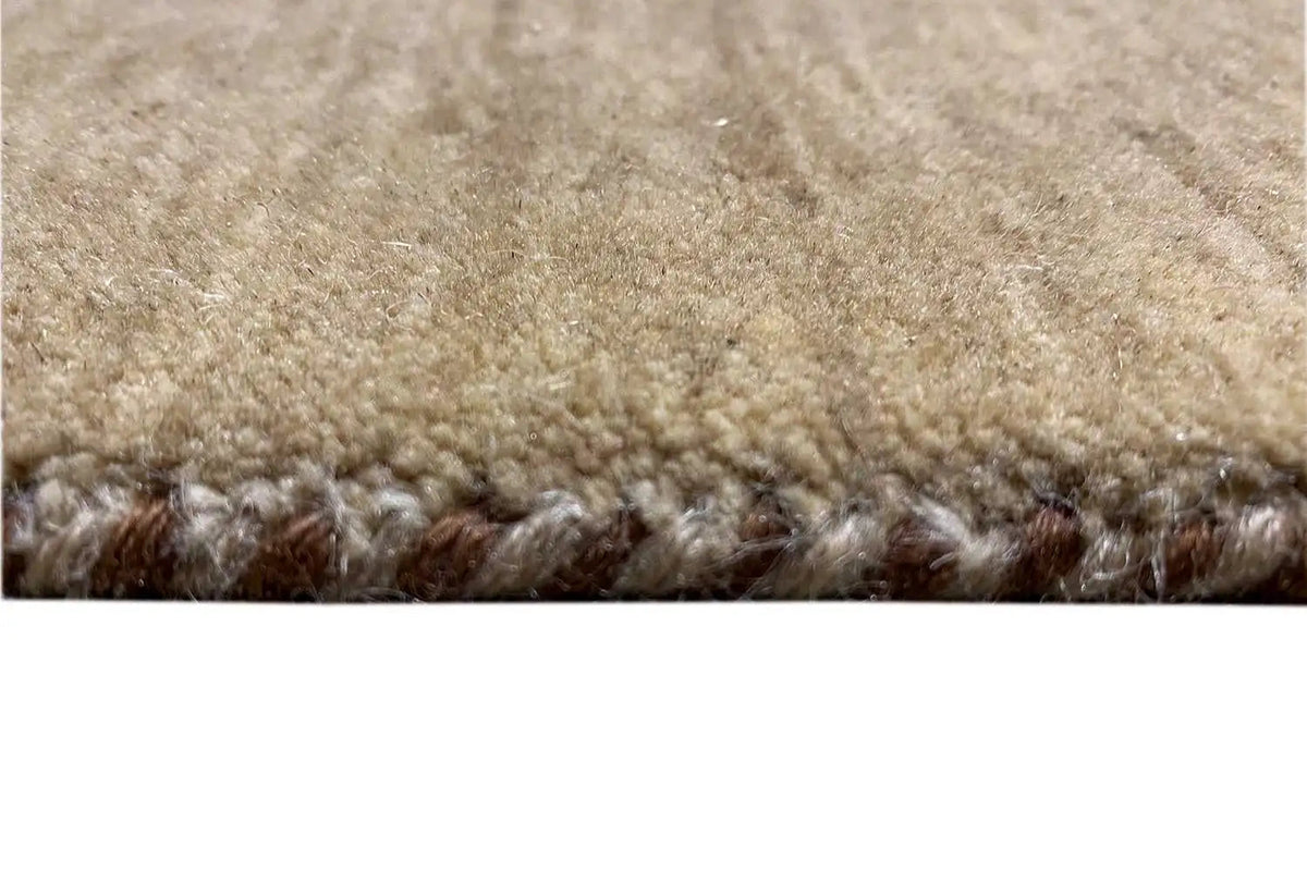 Gabbeh rug close-up: dense pile with light and dark brown color transitions