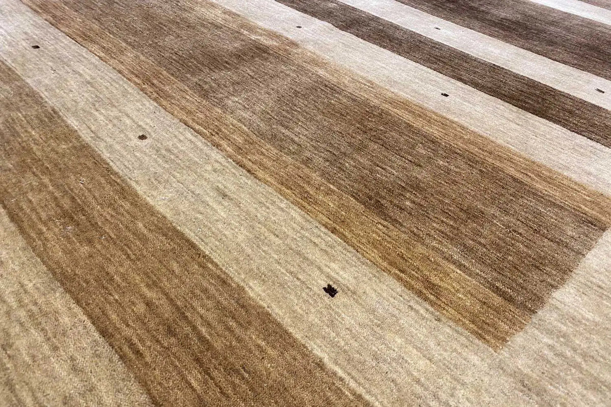 Gabbeh rug detail: rustic stripes in brown and beige, fine patterned dots