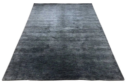 Large rug with a dark blue-gray, heathered design and short, dense pile