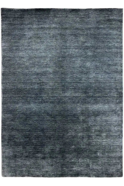 Rectangular rug in dark blue-gray with a mottled, irregular surface pattern