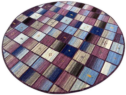 Oval Gabbeh rug surface with checked patchwork in shades of blue, purple, and beige