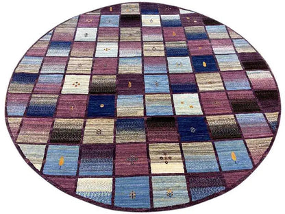 Oval gabbeh rug surface with colorful patchwork squares, predominantly blue and burgundy