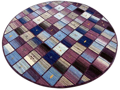 Oval gabbeh rug with striped patchwork in blue, purple, beige, and dark gray