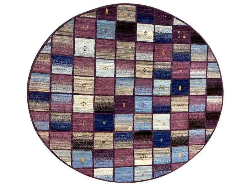 Oval Gabbeh rug surface with patchwork squares in blue, burgundy, and beige