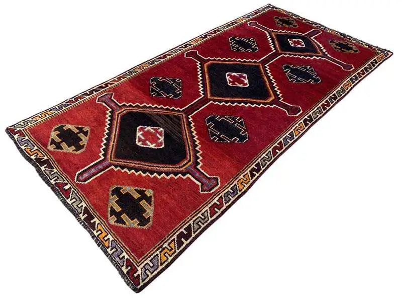 Lorry carpet with a red background, black hexagons, and a beige border with a zigzag pattern.