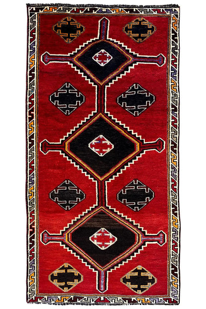 Gabbeh Lori rug with a geometric diamond pattern, red background, multicolored border