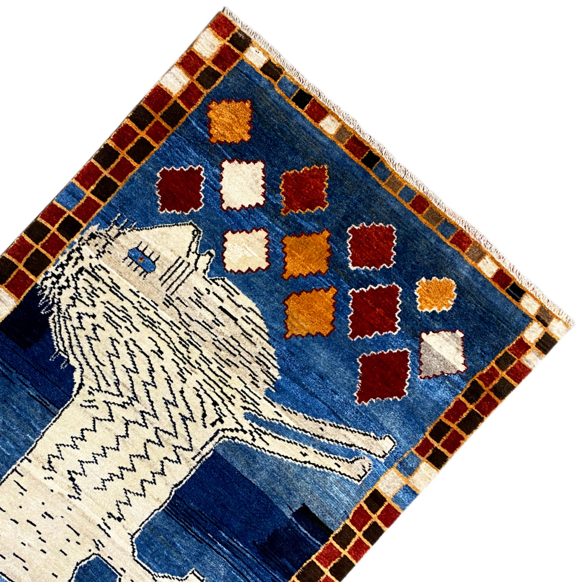 Gabbeh rug corner with a white lion, colorful diamonds, and a checked border.