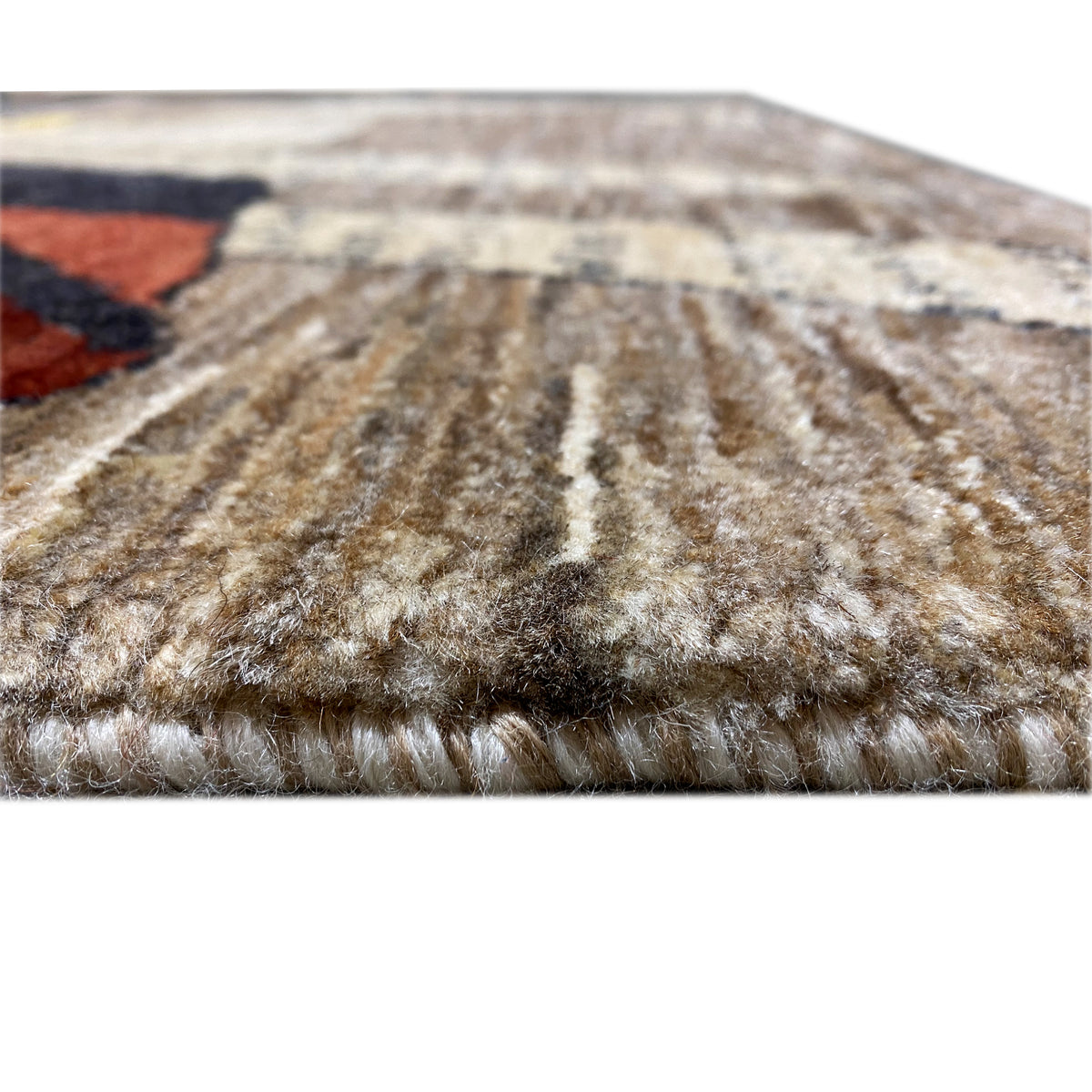 Gabbeh rug close-up of the pile surface in brown and beige with patterned edges