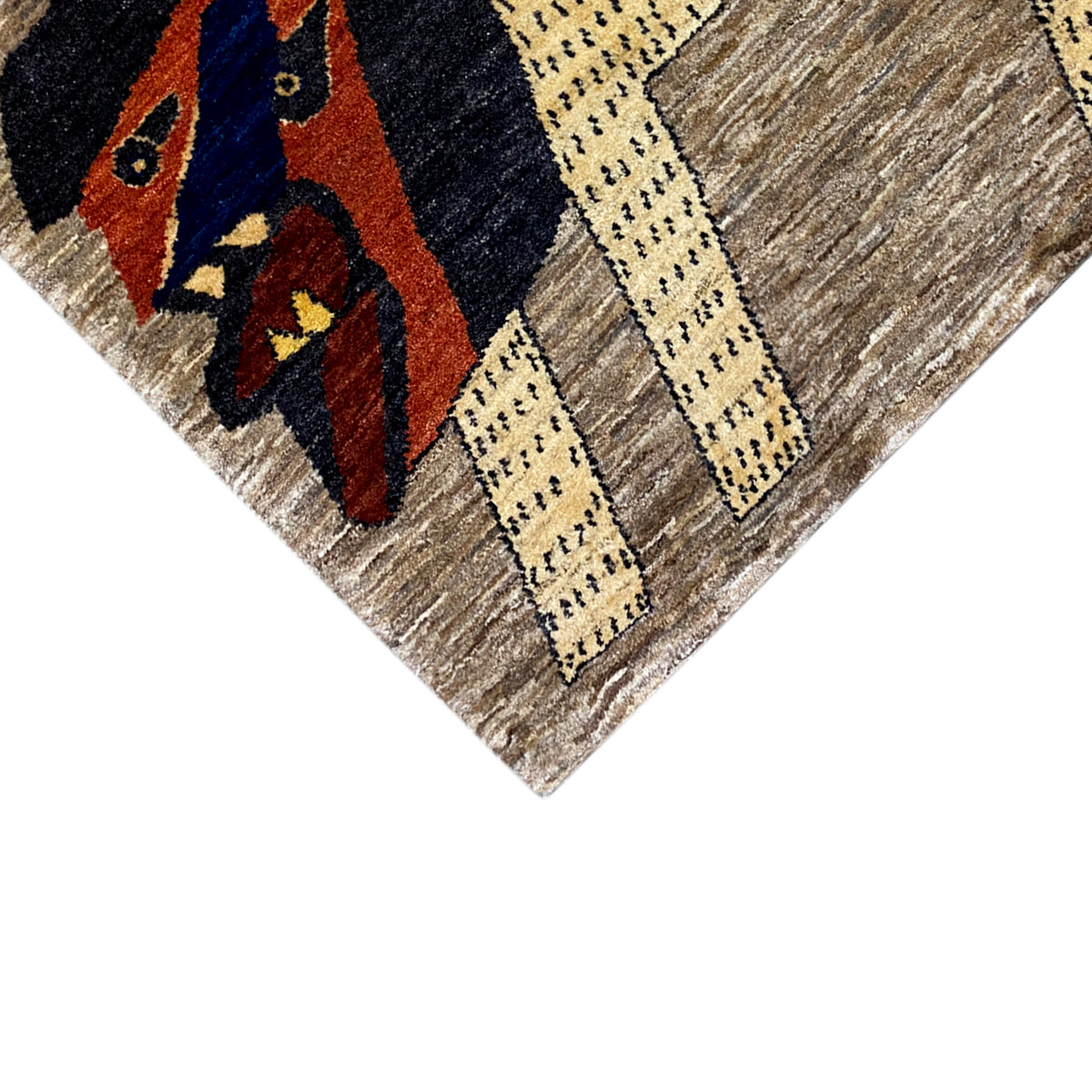 Gabbeh rug close-up: lion motif with yellow lines on a brown background