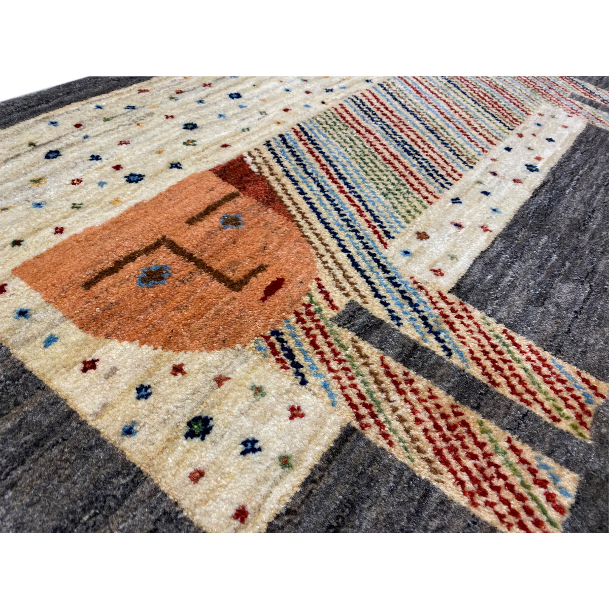 Gabbeh rug close-up: orange elephant face, colorful stripes